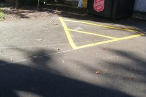New yellow hatched box marking painted on a car park surface