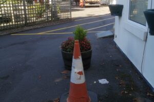 Newly marked car park area with a traffic cone after line marking