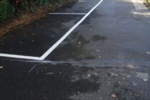 New white parking bay line painted on tarmac after re-lining