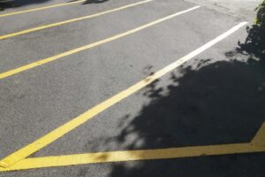Yellow hatched markings freshly painted on tarmac