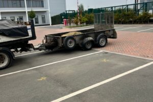 Trailer beside new white bay markings in a commercial car park