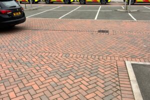 White bay lines marked on a red block paving car park