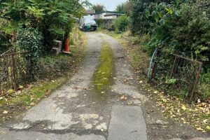 Worn gravel lane before tarmac resurfacing