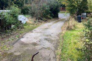 Cracked concrete drive before tarmac resurfacing