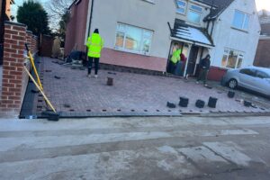 Groundworkers laying the base for a block paving driveway