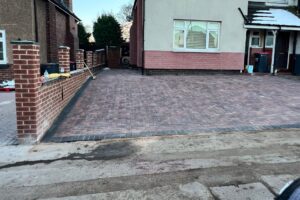 New red block paving driveway in front of a house