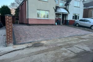 Completed block paving driveway with brick pillars and front wall