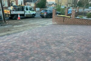 Block paving driveway and brick boundary wall at a semi-detached house