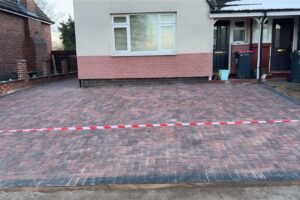 Block paving driveway nearing completion with barrier tape